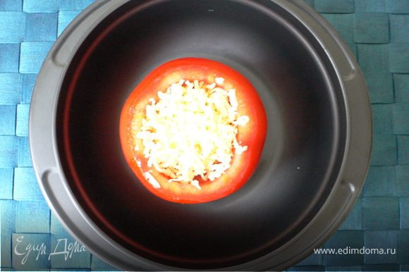 Внутрь помидора разбить яйцо, посолить,поперчить и посыпать натёртым сыром
