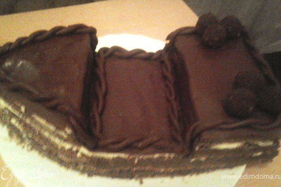 Шоколадную мастику раскатать, покрыть ей верхний слой торта. Вылепить 2 длинных жгутика, перевить и украсить ими торт.