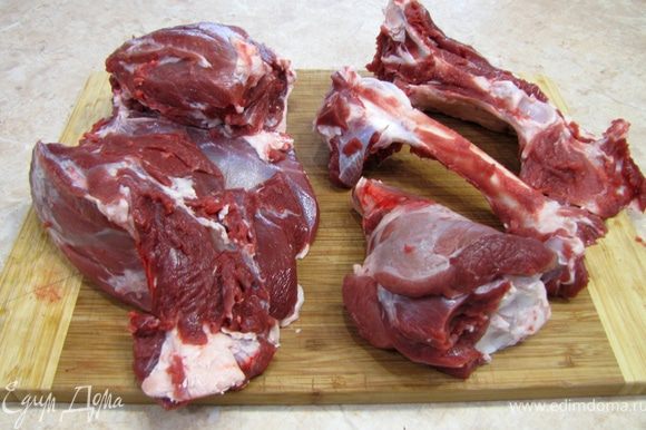 Срежьте мясо с бедра бараньей ноги, предварительно сняв корочку подсыхания и жилы. Порежте мясо на куски.