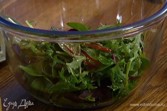 Листья салата посолить и поперчить, сбрызнуть оливковым маслом и разложить поверх салата.