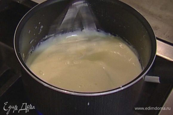 Снять кастрюлю с огня и ввести к муке с молоком натертый сыр, перемешивая, пока он полностью не растворится.