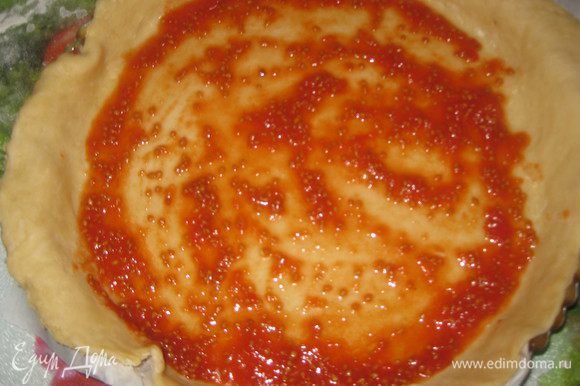 Готовим соус: для этого помидоры измельчаем блендером в пюре, добавляем сахар, соль. Тесто раскатываем в круг диаметром примерно 40 см. Смазываем соусом, оставляя по 5 см теста по краях без соуса