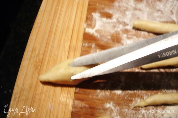 Каждую из колбасок надрезаем со всех сторон при помощи ножниц.