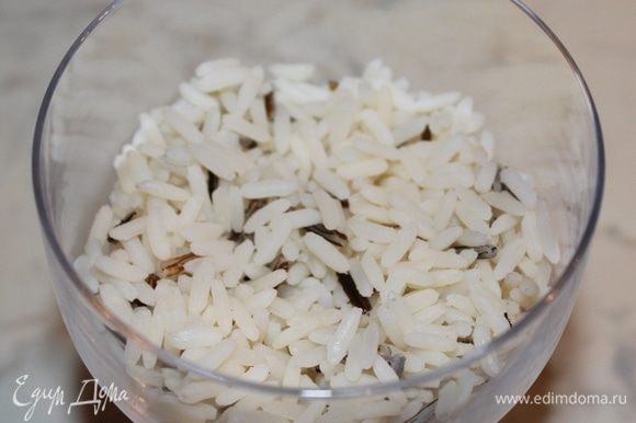 Рис отварить до готовности. Он должен быть рассыпчатым. Первым слоем салата выкладываем рис.