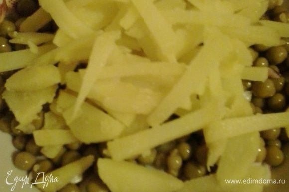В салатник с луком и кальмарами добавляем горошек и нарезанный соломкой картофель.