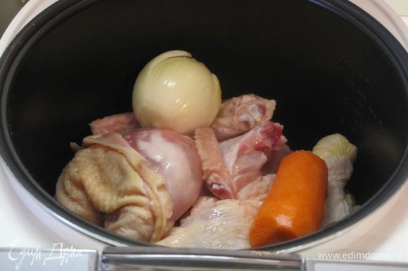 Курицу промыть, разрезать на 4 части, выложить в чашу мультиварки. Добавить очищенные морковь и репчатый лук.