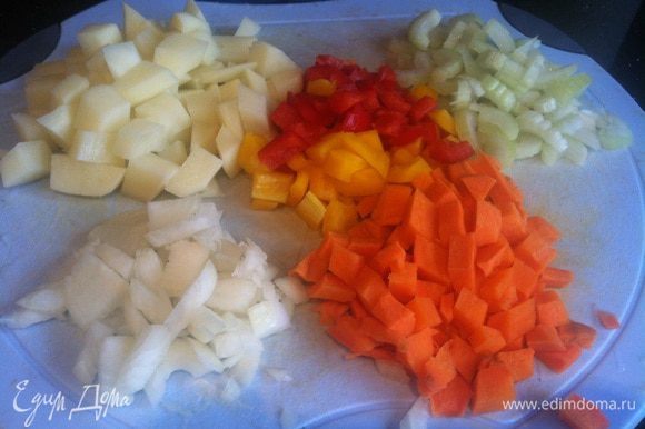Почистите картофель, лук и морковь, у болгарского перца удалите семена. Тонко нарежьте сельдерей, лук - помельче, а картофель, морковь и болгарский перец - кубиком.