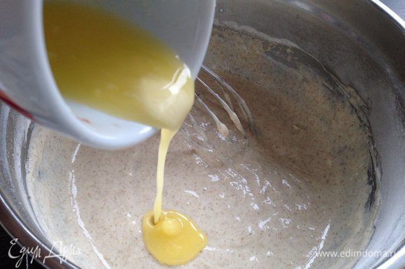 К получившейся кефирно-яичной массе добавить сухие ингредиенты, перемешать до однородности. Влить растопленное сливочное масло.