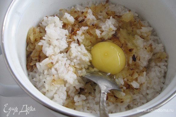Отварить рис в подсоленной воде, можно это сделать заранее. Добавить к рису жареный лук и одно яйцо. Перемешать.
