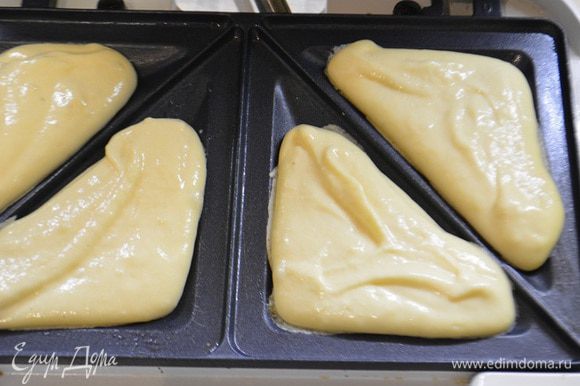 Сэндвичницу нагреть и смазать маслом с помощью кисточки.Выложить тесто в ячейки,получается по 1,5 ст.л. (на фото по 1 ст.л, я потом докладывала до конца).