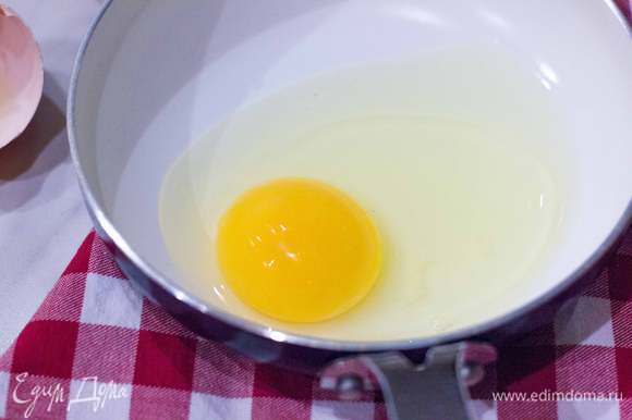 На оставшемся оливковым маслом приготовьте глазунью из двух яиц так, чтобы желтки оставались чуть жидковатыми. В конце приготовления посолите и поперчите.