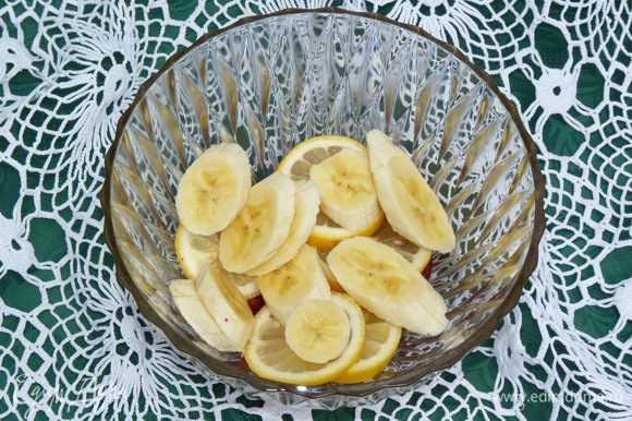 Нарезать бананы и сложить к фруктам.