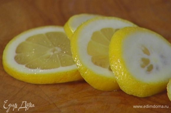 Половинку лимона нарезать тонкими кружками.