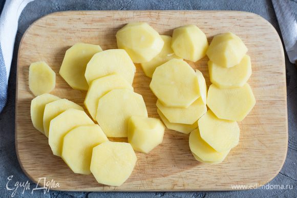 Картофель почистите и нарежьте тонкими кружочками. Выложите картофель в небольшую кастрюлю, залейте кипятком, добавьте шафран, доведите до кипения и варите 4 минуты.