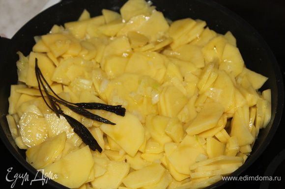 В горячее масло погрузите картофель вместе с луком и, периодически мешая, тушите в масле до готовности картофеля.