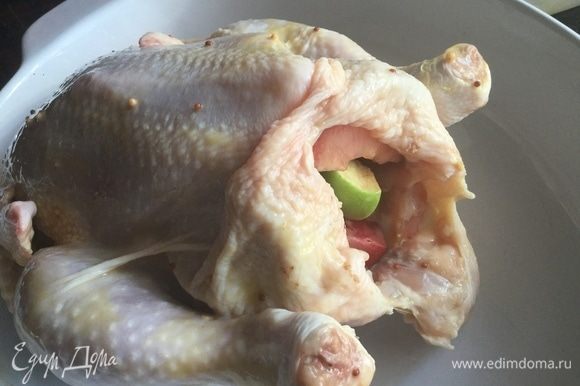Начините курицу сливами и яблоками. Брюшко курицы зашейте или скрепите зубочисткой. Ножки свяжите кулинарной нитью.