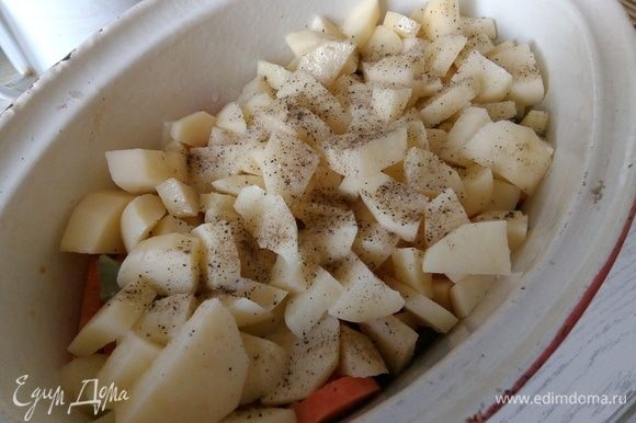 Картофель очищаем от кожуры, моем, режем на кубики. Посыпаем солью и перцем, перемешиваем и раскладываем сверху.
