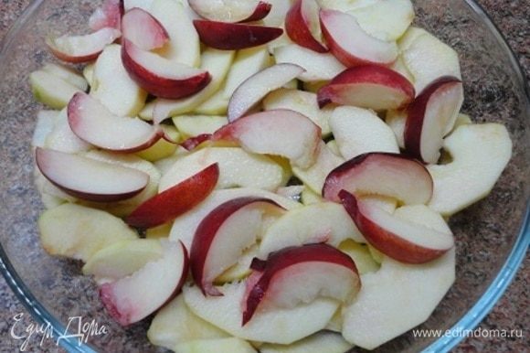 Включаем плиту для разогрева на 200°C. 2 крупных яблока (у меня сорт Симиренко) очистить от семян и нарезать дольками. Выложить в форму для запекания и полить лимонным соком. Сверху выложить дольки нектарина.