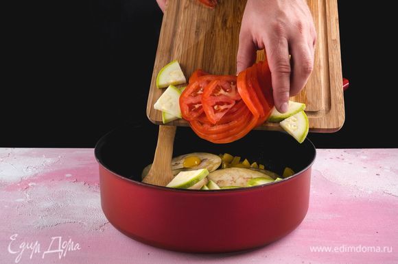 В сковороду с овощами добавьте помидор и кабачок, слегка посолите, перемешайте и все обжарьте.