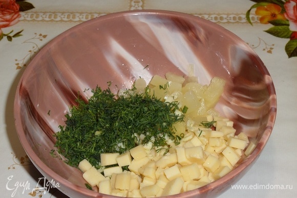Выкладываем в чашку сыр, ананас, чеснок и зелень.