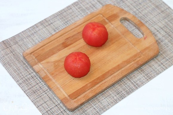 На помидорах сделать крестообразный надрез, поместить их в глубокую посуду и залить кипятком.