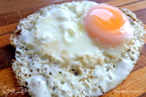На плоской сковороде жарим яйцо с недожаренным желтком. Солим крупной солью.