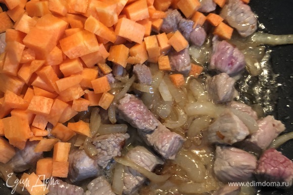 Половинку морковки нарезаем кубиками и добавляем к мясу с луком. Тушим на слабом огне 5–7 минут, солим и добавляем специи по вкусу.