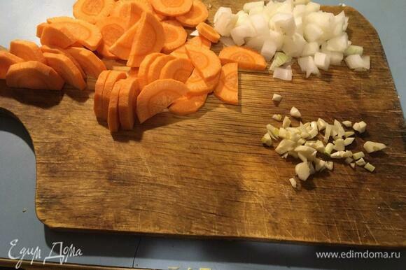 Нарезаем лук, морковь и чеснок. Вы можете нарезать морковь произвольно или потереть на терке. В готовом блюде морковь будет приятно выделяться яркими пятнами.