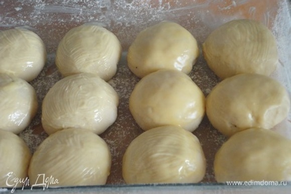 Выложить булочки швом вниз в подготовленную форму. Щедро смазать поверхность булочек топленым сливочным маслом. Накрыть форму с булочками слегка влажным полотенцем и оставить на 45 минут подрастать. Разогреть духовку до 170°C.