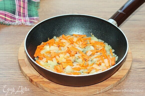 Добавляем морковь и пассеруем овощи на слабом огне 2–3 минуты.