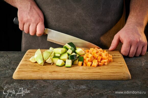 Приготовьте начинку. Лук порубите, цукини и морковь нарежьте кубиками.