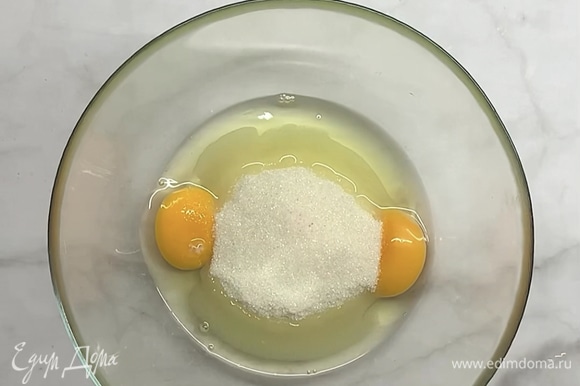 В яйца добавляем сахар и 1 щепотку соли, перемешиваем венчиком.
