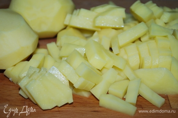 Картофель вымойте, очистите и нарежьте на средние брусочки.