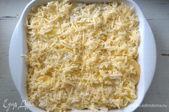 Сверху засыпать картофель отложенным сыром. Поставить форму в духовку, предварительно разогретую до 200°С, на 40–45 минут.