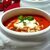 Согревающий суп из запеченного сладкого перца с томатами, сметанным базиликом и кедровыми орешками